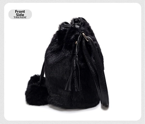 Detail view of black faux fur bucket bag with drawstring closure and matching pompom