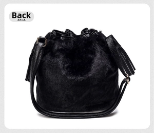 Rear view of black faux fur bucket bag with lychee grain leather drawstring and gold hardware