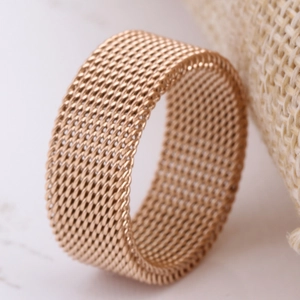 Macro shot of 8mm rose gold mesh band ring with a detailed woven metal texture design
