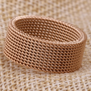 Macro shot of 8mm rose gold mesh band ring showing fine woven metal texture and detail