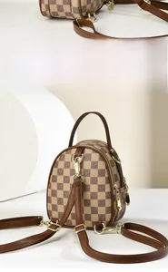 Detail of mini checkered backpack with gold zippers and adjustable shoulder straps