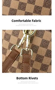 Detail view of brown checkerboard fabric texture and golden hardware buckle for handbags