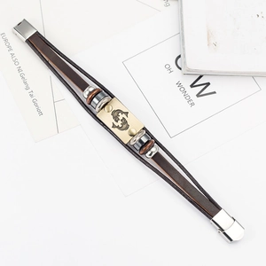 Detail of multi-layer brown leather bracelet with Pisces zodiac plate and steel clasp