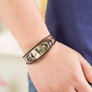 Close-up of Aries zodiac leather bracelet with bronze plaque and metallic beads