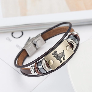 Detail of multi-layer brown leather bracelet with Aries zodiac bronze metal plate