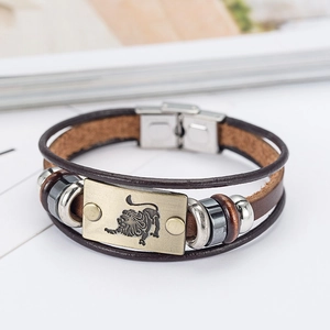 Vintage brown leather woven Leo zodiac bracelet with retro metal plate and silver clasp