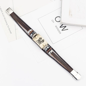 Detailed macro view of Gemini zodiac sign engraved on a brown leather bracelet
