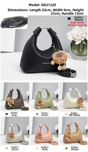 Detail view of stylish women's satchel bag with dimensions 22x9x23cm and plush charm