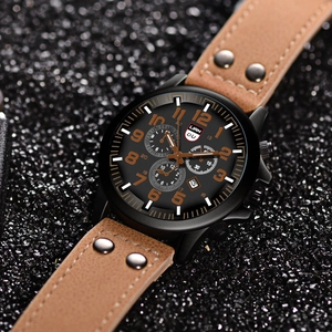Macro detail of men quartz watch with brown leather strap and orange numerals