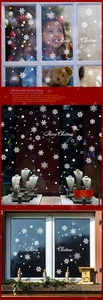 Detail showing white snowflake and Merry Christmas wall stickers on shop window glass