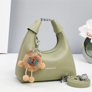 Green lychee pattern leather crescent handbag with metal buckle and bear charm