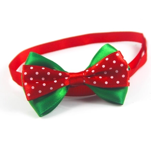 Detail view of a festive red and green polka dot pet bowtie with adjustable strap