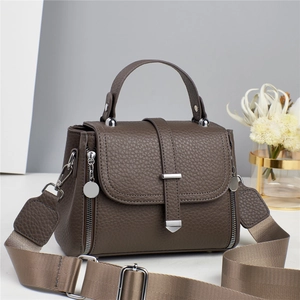 Dark taupe pebbled leather crossbody bag for women with wide fabric strap and top handle