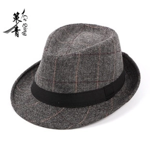 Detail showing grey plaid wool fedora hat with a black silk ribbon trim for winter