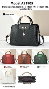 Detail view of stylish croc-effect handbag with metal ring handle and deer charm