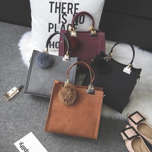 Detailed view of four frosted suede handbags in burgundy, grey, black and brown colors