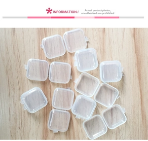 Detailed top view of transparent square plastic storage boxes on wooden background
