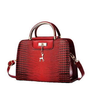 Burgundy faux crocodile leather handbag with gold deer charm and top handle strap