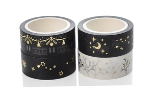 Detail of Christmas washi tape with gold foil star, moon, and house patterns for DIY crafts