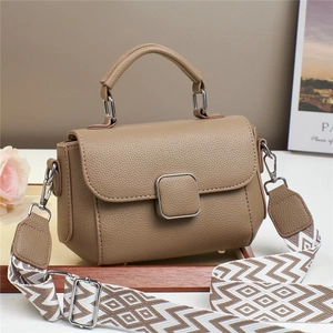 Detailed macro view of litchi-grain leather texture with decorative silver metal buckle