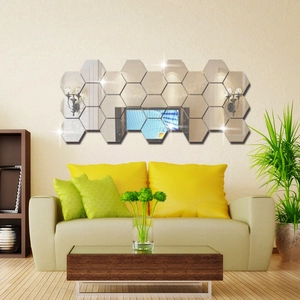 Detail of hexagonal acrylic mirror wall stickers arranged on a modern living room wall