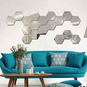 Set of silver hexagonal acrylic mirror wall stickers in a modern living room setting