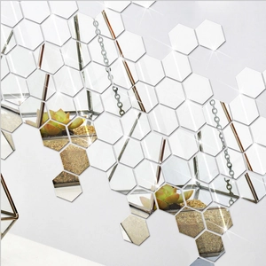Close-up of hexagonal silver acrylic mirror wall stickers in a creative DIY arrangement