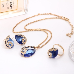 Detail of gold-plated jewelry set featuring blue teardrop crystals and small diamonds