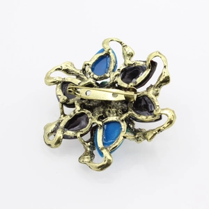 Floral teardrop resin gemstone brooch in vintage gold tone with blue and purple crystals