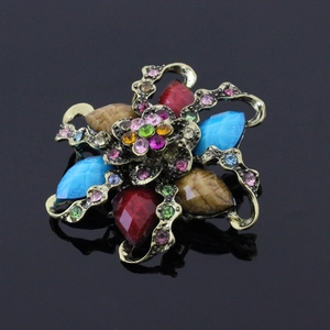 Detailed view of vintage flower brooch with colorful teardrop resins and crystals
