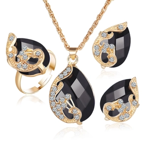 Gold-plated jewelry set with black teardrop crystals including necklace, ring and earrings