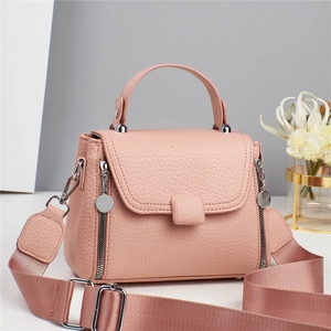 Pink lychee texture leather handbag with silver hardware and a wide crossbody strap