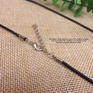 Close-up of black wax cord necklace with silver lobster clasp and adjustable extension chain