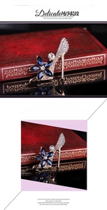 Detailed close-up of a high heel brooch with blue gemstones on vintage books