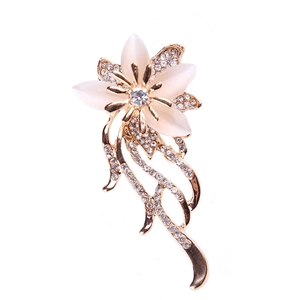 Detailed view of flower brooch with golden petals and sparkling crystal rhinestones