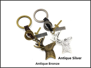 Detail of deer head charms and leather braided keychains in antique bronze and silver