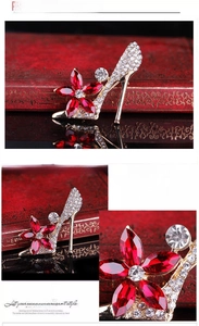 Detailed macro view of high heel brooch with red crystal flower and shimmering rhinestones