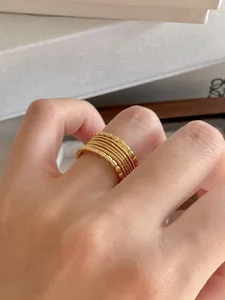 Close-up of a layered gold beaded ring set featuring a vintage minimalist aesthetic