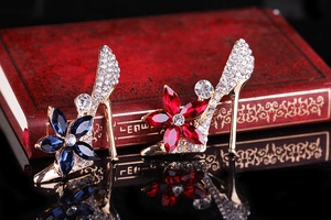 Detailed view of luxury crystal high heel brooches with red and blue gem flowers