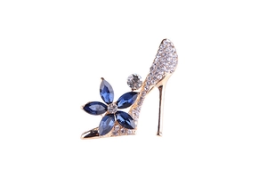 Detailed close-up of high-heel brooch with blue gem flowers and sparkling rhinestones