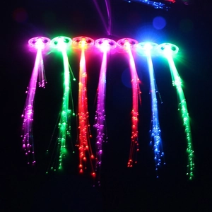 Colorful LED fiber optic hair clips showing multiple light-up colors on a dark background