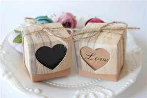 Detail view of kraft paper favor boxes with heart cutouts and rustic hemp rope ties