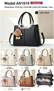 Close-up of litchi pattern PU leather handbag with metallic bar and cute bear charm