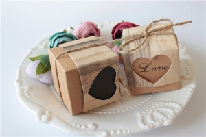 Close-up of wood grain favor box with heart-shaped cutout and rustic twine bow