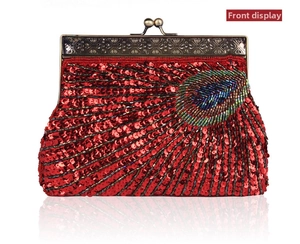 Close-up of vintage evening clutch featuring red sequins and beaded peacock feather detail