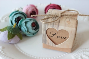 Detail of kraft paper wedding favor box with heart cutout, Love text and twine bow