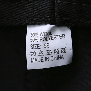 Detail of wool blend hat lining with tag showing 50% wool and 50% polyester fabric