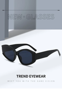 Macro detail of trendy black polygon sunglasses with thick glossy temples and dark lenses