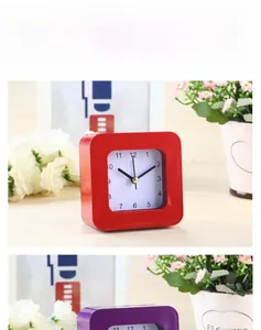 Detail view of square quartz alarm clocks in red and purple colors for home decor