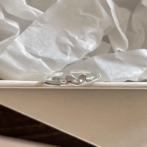 Minimalist 925 sterling silver open heart ring with abstract face design on white box